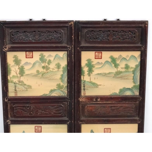 454 - A large pair of Chinese ceramic panels in wooden frames, each having two panels decorated with river... 