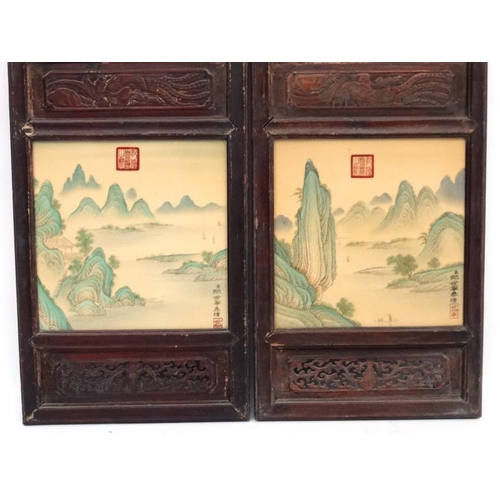 454 - A large pair of Chinese ceramic panels in wooden frames, each having two panels decorated with river... 