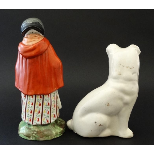 460 - A Victorian Staffordshire figure depicting an elderly female wearing red cloak, tied bonnet and hold... 