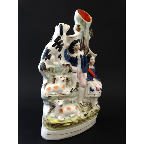 462 - A 19th C Staffordshire flatback spill vase, decorated in polychrome with a shepherd and shepherdess ... 