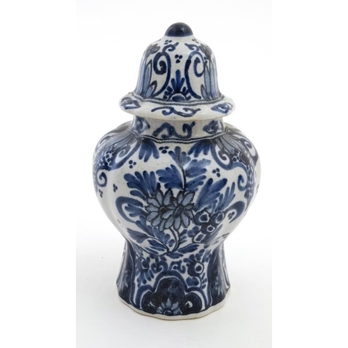 474 - A small blue and white Delft lidded baluster form jar and cover, having stylised floral decoration t... 