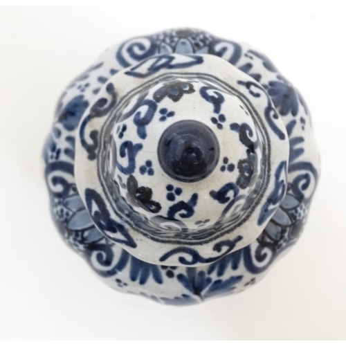 474 - A small blue and white Delft lidded baluster form jar and cover, having stylised floral decoration t... 