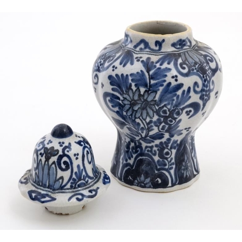 474 - A small blue and white Delft lidded baluster form jar and cover, having stylised floral decoration t... 