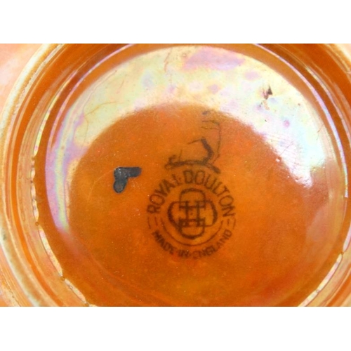 487 - A small Royal Doulton lustre glazed orange bowl, bears factory stamp to base. 5 1/4'' diameter.