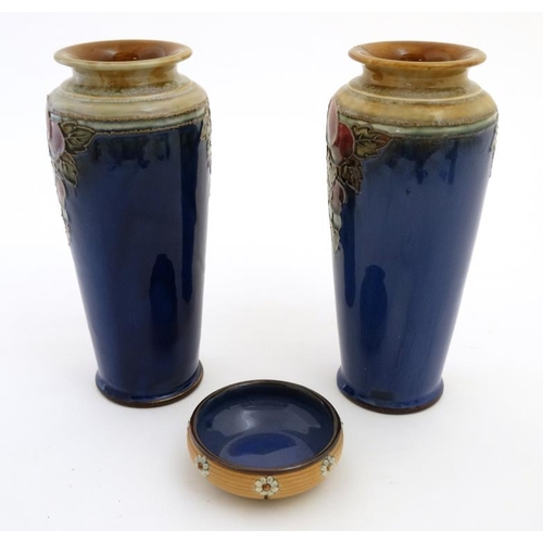 490 - A pair of Royal Doulton Lambeth tall vases, number X8795D 2410, decorated with fruit on a cobalt blu... 