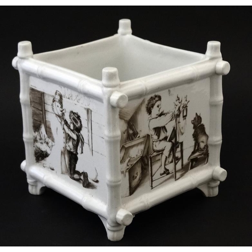 583 - A black and white transfer printed  jardiniere of square form , the panels decorated with scenes of ... 