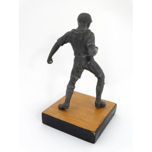 113 - A mid 20thC cast metal model of a footballer? Probably Russian. On wooden base. The whole 6 3/4'' hi... 