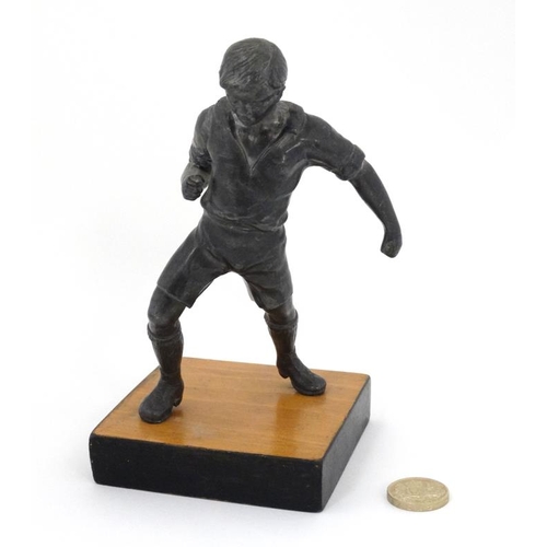 113 - A mid 20thC cast metal model of a footballer? Probably Russian. On wooden base. The whole 6 3/4'' hi... 