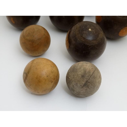 119 - A collection of 11 lawn bowls / boules of various sizes to include a number of lignum vitae examples... 