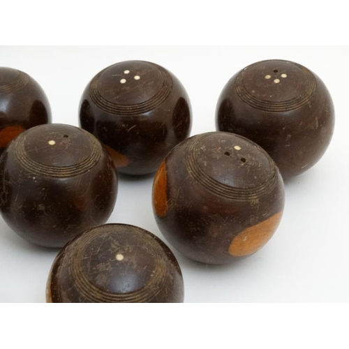 119 - A collection of 11 lawn bowls / boules of various sizes to include a number of lignum vitae examples... 