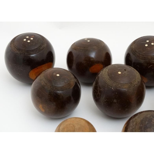 119 - A collection of 11 lawn bowls / boules of various sizes to include a number of lignum vitae examples... 