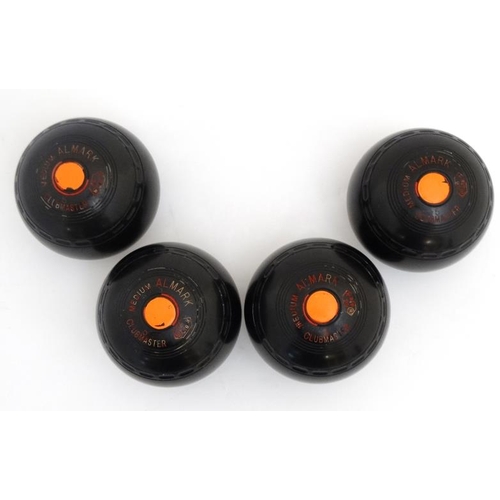 120 - Lawn Bowls: A set of 4 Almark Clubmaster size 5 Medium bowls / boules, marked A J B to top. 4 3/4'' ... 