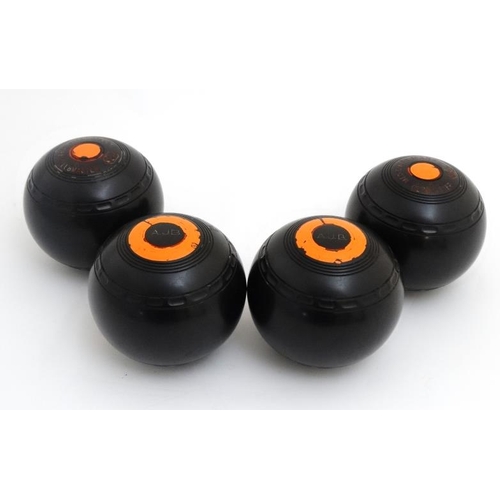 120 - Lawn Bowls: A set of 4 Almark Clubmaster size 5 Medium bowls / boules, marked A J B to top. 4 3/4'' ... 