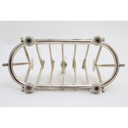 122 - A novelty 6-slice silver plated toast rack, the bars formed as crossed cricket bats.  21stC  . Appro... 