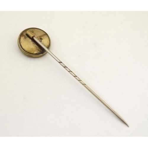 210 - Hunting interest : An early 20thC stick pin surmounted by a ceramic cabochon depicting the head of a... 