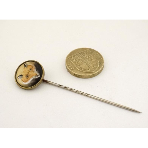 210 - Hunting interest : An early 20thC stick pin surmounted by a ceramic cabochon depicting the head of a... 