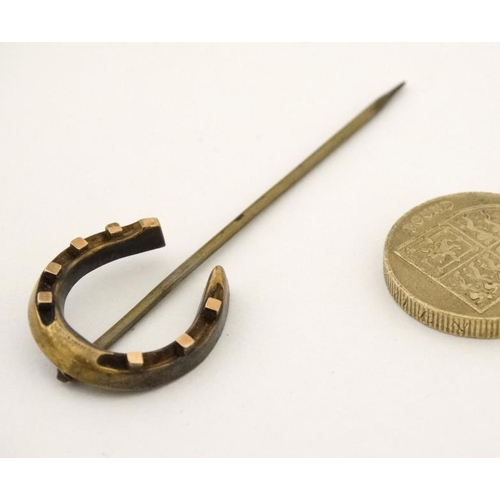 212 - A gilt metal stick pin surmounted by a horseshoe 2 3/4'' long