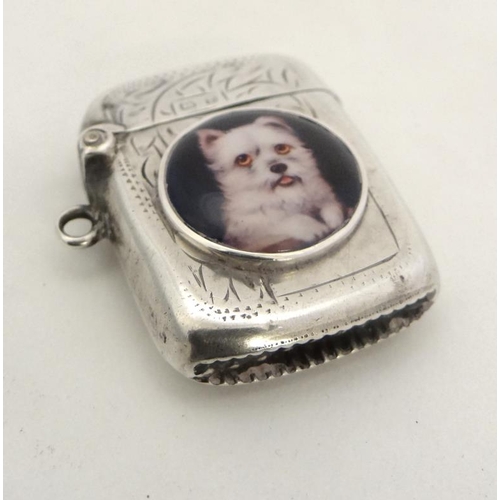 216 - A silver vesta case with hinged lid and striker under. Hallmarked Birmingham 1916  with later applie... 