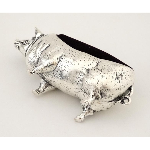 219 - A white metal pin cushion formed as a pig. 21stC. Approx 4'' long