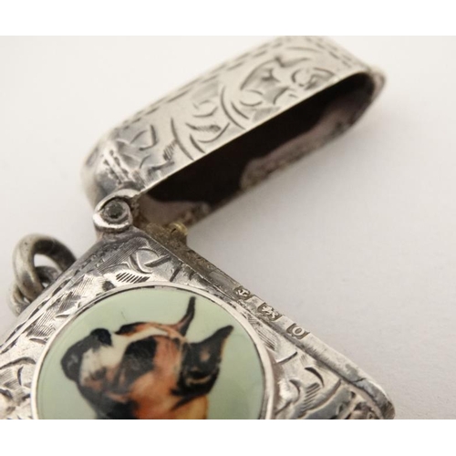 221 - A silver vesta case with later applied 21stC ceramic cabochon with dog decoration. The whole 1 3/4''... 