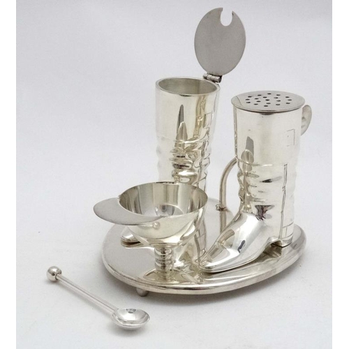 222 - A novelty silver plate cruet comprising pepper and mustard pots formed as riding boots and the salt ... 