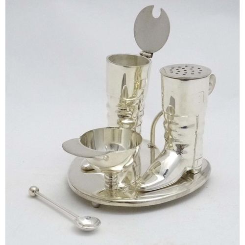 222 - A novelty silver plate cruet comprising pepper and mustard pots formed as riding boots and the salt ... 