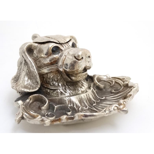 259 - A silver plate inkwell in the form of a dog's head with a C shaped Rococo Revival pen dish with glas... 