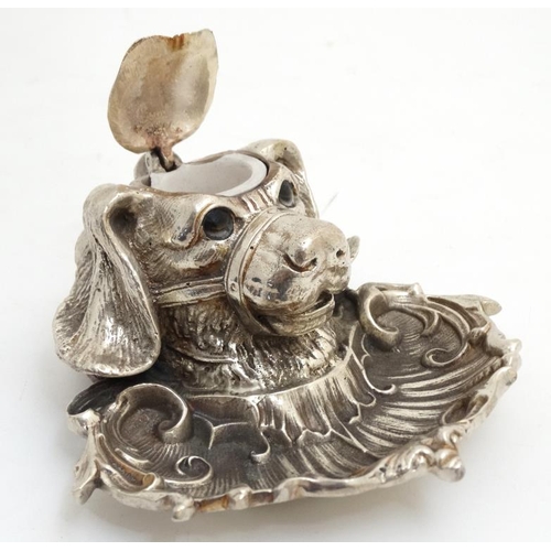 259 - A silver plate inkwell in the form of a dog's head with a C shaped Rococo Revival pen dish with glas... 