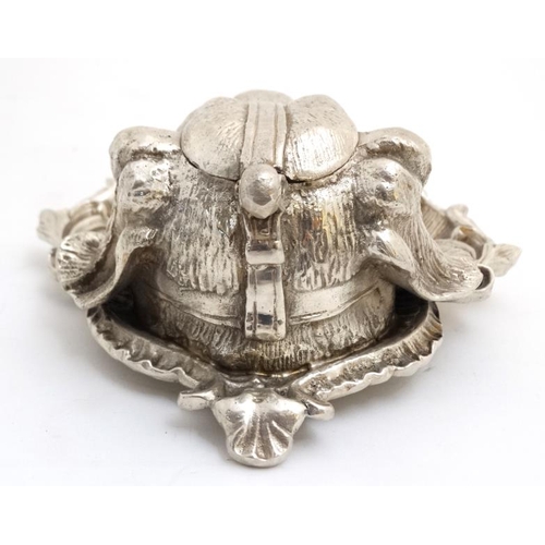 259 - A silver plate inkwell in the form of a dog's head with a C shaped Rococo Revival pen dish with glas... 