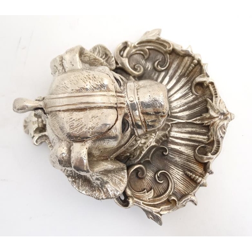 259 - A silver plate inkwell in the form of a dog's head with a C shaped Rococo Revival pen dish with glas... 