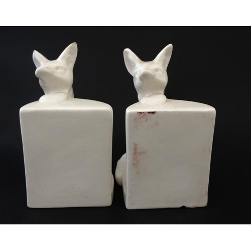 275 - Ceramic Bookends : a pair of continental white glaze bookends formed as foxes peering over a wall , ... 