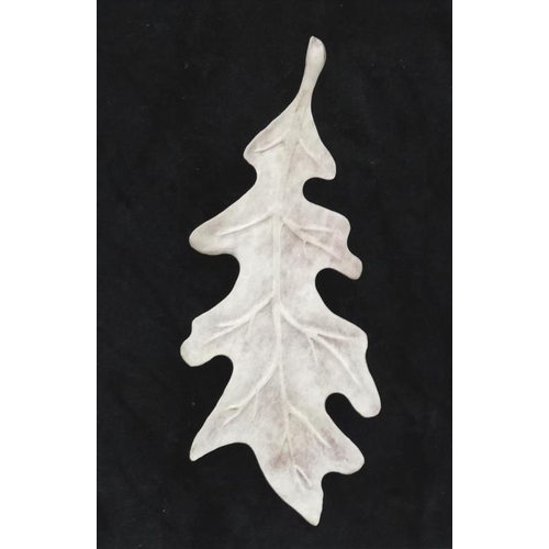 57 - Taxidermy : An antler carved oak leaf , mounted upon a black velvet background. Framed. Approximatel... 