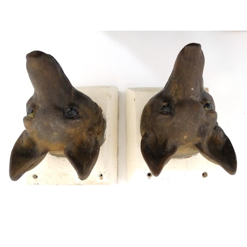 69 - A pair of 19thC cast iron stylised fox masks on squared plinths. For external use 8'' deep x 6 3/4''... 