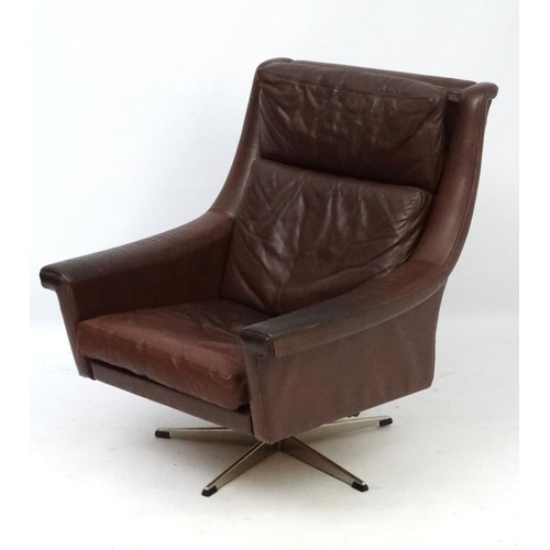 148 - Vintage Retro :A Danish brown leather swivel and tilt armchair  supported on a 5 spoke chromed base,... 