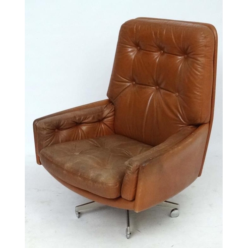 149 - Vintage Retro : - A Danish Farstrup Brown Leather Tilt and Swivel armchair with button back upholste... 