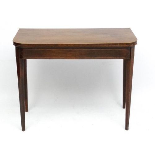 162 - A late 18thC mahogany fold over card table with squared tapering legs and two hinged back legs. 26''... 