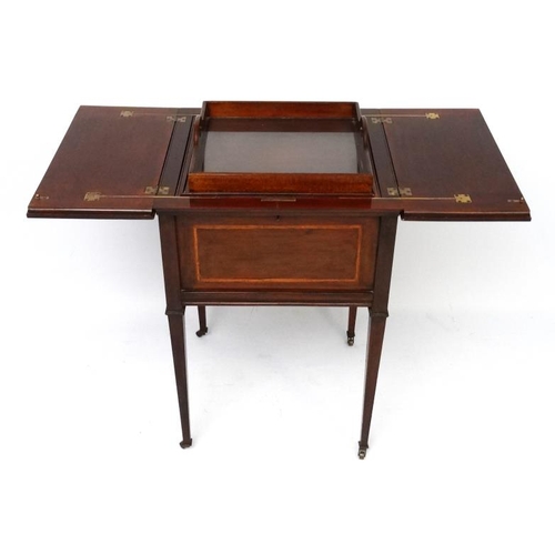 166 - An Edwardian inlay mahogany drinks cabinet with raising shelf and glass bottomed tray within. 21 7/8... 