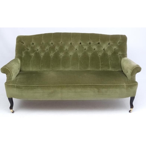 174 - A late Victorian button back green draylon upholstered three-seat sofa 70'' wide x 35'' high