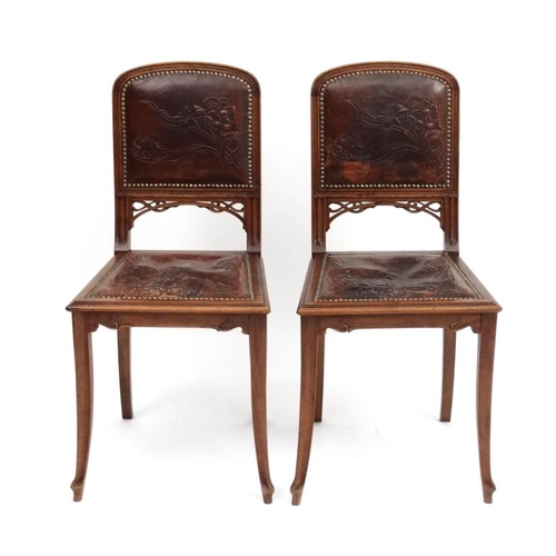 178 - Art Nouveau : Manner of Gailliard , a pair of Continental walnut salon chairs  with embossed leather... 