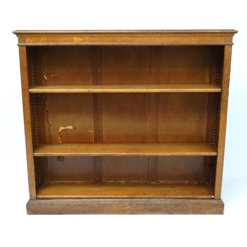 180 - A late 19th oak open bookcase with adjustable height shelves 60'' wide x 54 1/2'' high x 13 1/4'' de... 