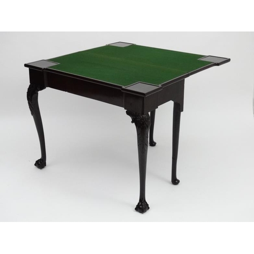 185 - An early - mid 18thC mahogany fold over card table with pad feet and ball and claw cabriole legs, on... 