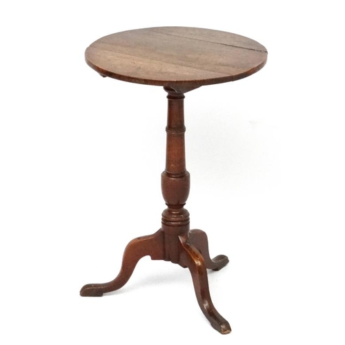 187A - A circa 1800  oak tilt top , tripod table with circular top measuring 18 1/4'' diameter and standing... 