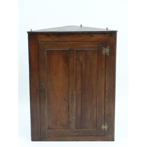 193 - An early 19thC oak panelled corner cupboard 41'' high