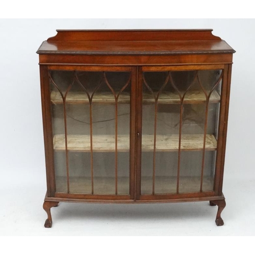 194 - A 1930's walnut bow front display cabinet. 47 1/2'' wide