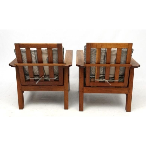 203 - Arts and Crafts : a pair of early 20thC oak armchairs with adjustable rake back , arm rests and side... 