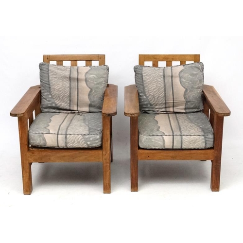 203 - Arts and Crafts : a pair of early 20thC oak armchairs with adjustable rake back , arm rests and side... 