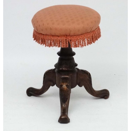 205 - A Victorian walnut adjustable height tripod piano stool.