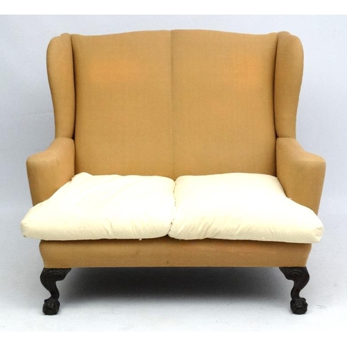 209 - A c.1900 Queen Anne style 2-seat wing back sofa with carved mahogany cabriole ball and claw legs. 42... 