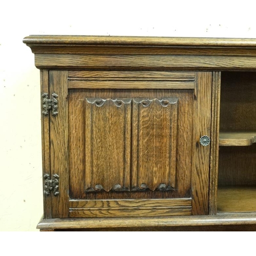 214 - An oak sideboard with carved and linen fold decoration together with a matching corner cupboard and ... 