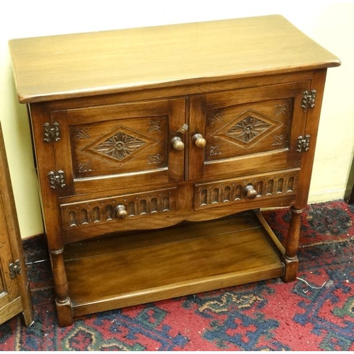 214 - An oak sideboard with carved and linen fold decoration together with a matching corner cupboard and ... 